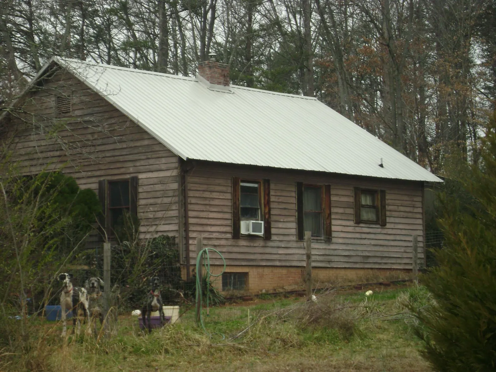 White metal roof on an old wood sided farmhouse, from a Metal Roof Installation job in Gates Mills